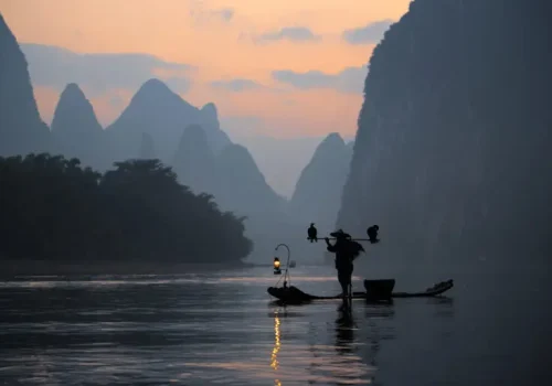 Silhouette,Fisherman,And,Cormorant,In,Guilin,China.